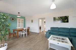 a living room with a blue couch and a table at Casa Elvira in Frontera +24 photos