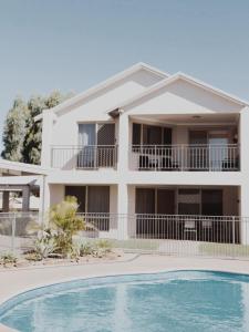 a house with a swimming pool in front of it at Kawa House in Kalbarri