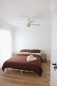 a bedroom with a bed with a brown blanket at Kawa House in Kalbarri +18 photos