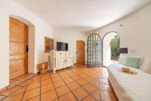 a living room with a couch and a tv at Villa Roccia in Porto Rotondo