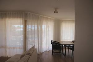a living room with a couch and a dining room table at Kawa House in Kalbarri