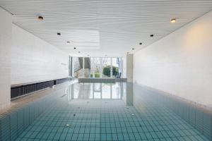 an empty swimming pool with a green tile floor at Schönblick in Höchenschwand
