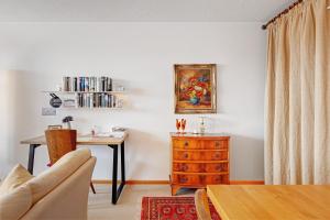 a living room with a table and a wooden dresser at Schönblick in Höchenschwand