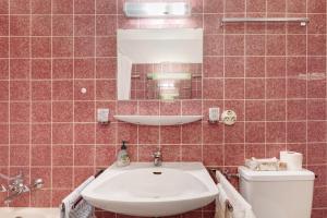 a bathroom with a sink and a toilet and a mirror at Schönblick in Höchenschwand +23 photos