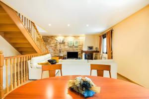 a kitchen and living room with a table and a staircase at Juanikoenea in Leitza