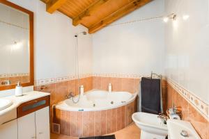 a bathroom with a tub and a sink and a toilet at Juanikoenea in Leitza +24 photos
