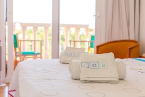 a bedroom with a bed with towels on it at Villa Lidia in Cala Galdana +22 photos