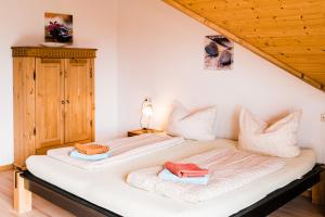 a bedroom with two beds with towels on them at Jonagold in Stockach