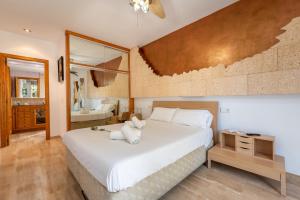a bedroom with a large white bed and a bathroom at Villa Sayana in Palma de Mallorca +16 photos