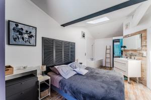 a bedroom with a king sized bed and a sink at La Villa Sanson in Arcachon +27 photos