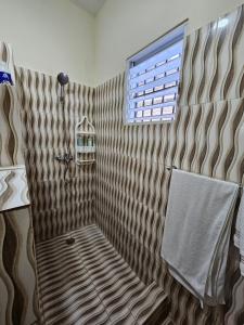 a shower with a bench in a bathroom with a window at Caribbean Domicil Apartment 02 in Las Terrenas +9 photos