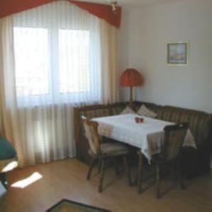 a room with a table and a couch with a table and chairs at Haus Lechner in Cuxhaven +17 photos