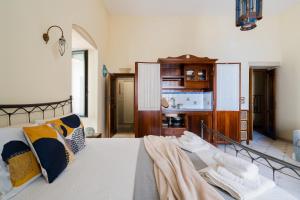 a bedroom with a bed with pillows on it at Mono Scilla Centro Storico Otranto in Otranto