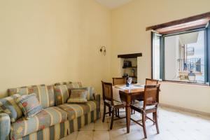 a living room with a couch and a table at Mono Scilla Centro Storico Otranto in Otranto +20 photos