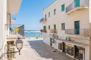 a street in a building with a view of the ocean at Mono Scilla Centro Storico Otranto in Otranto
