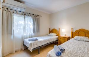 a bedroom with two beds and a window at Cala Deia in Deia