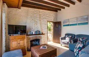 a living room with a couch and a fireplace at Cala Deia in Deia