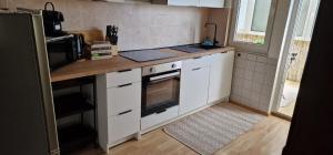 a kitchen with white cabinets and a counter top at M B Homes Albstadt in Albstadt