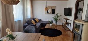 a living room with a couch and a table at M B Homes Albstadt in Albstadt