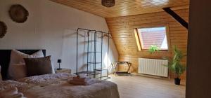 a bedroom with a bed in a room with a window at M B Homes Albstadt in Albstadt