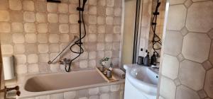 a bathroom with a bath tub and a sink at M B Homes Albstadt in Albstadt +9 photos