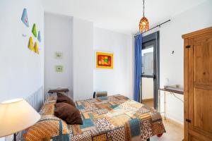 a bedroom with a bed and a lamp at Casa Frank in Conil de la Frontera +17 photos