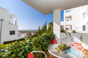 a table and chairs on a balcony with a view at Casa Frank in Conil de la Frontera