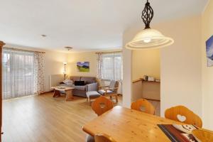 a living room with a table and a couch at Fewo Brünnstein - Nr 28 Pool, Sauna in Oberaudorf