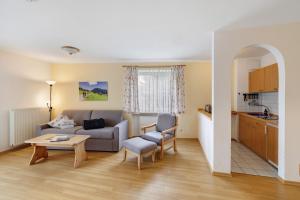 a living room with a couch and a table at Fewo Brünnstein - Nr 28 Pool, Sauna in Oberaudorf