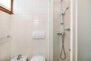 a bathroom with a shower with a toilet and a sink at Residence Larice Bianco App n4 in Campodolcino +22 photos