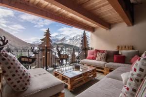 a living room with couches and a view of a mountain at Residence Larice Bianco App n4 in Campodolcino