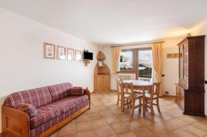 a living room with a couch and a table at Residence Larice Bianco App n4 in Campodolcino