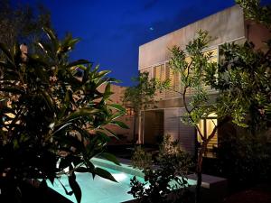 a house with a swimming pool in front of a building at Villa Mercedes in Artá