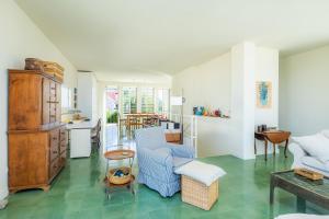 a living room with a blue chair and a couch at Villa Mercedes in Artá