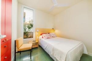 a bedroom with a bed and a chair and a window at Villa Mercedes in Artá +23 photos