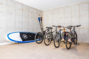 a group of bikes parked next to a surfboard at Villa Mercedes in Artá