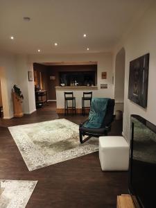 a living room with a chair and a table at Sonnige Ferienwohnung Am Sternberg in Extertal