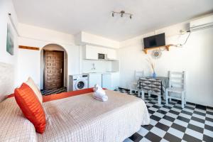 a bedroom with a bed and a table and a desk at Estudio Mirada 304 in Es Pujols