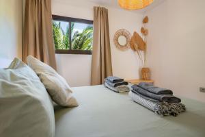 a bedroom with a bed with towels on it at Oasis Duna-Pistacho dreams Pool in Corralejo +23 photos