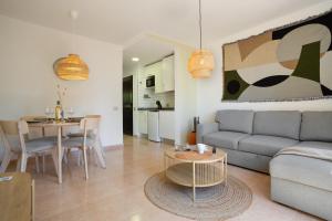 a living room with a couch and a table at Oasis Duna-Pistacho dreams Pool in Corralejo
