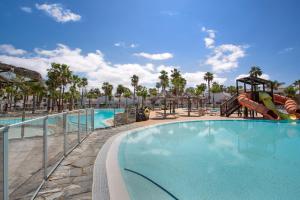 a swimming pool at a resort with a playground at Oasis Duna-Pistacho dreams Pool in Corralejo