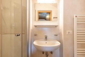 a bathroom with a sink and a shower at Unterhauserhof App C in Valdaora +8 photos