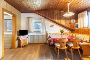 a dining room with a table and chairs at Unterhauserhof App C in Valdaora