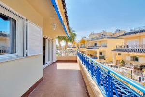 a balcony with blue railing and a view of the city at Casa en playa con piscina Novamar in Santa Pola