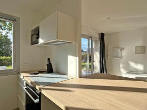 a kitchen with white cabinets and a counter top at Au p'tit Colombier in Hillion