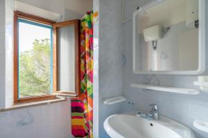 a bathroom with a sink and a window at Simona Panorama in Fetovaia +22 photos