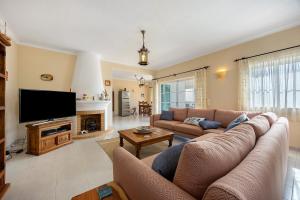 a living room with a couch and a tv at Monte Lemos Villa 35 in Luz