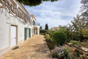 a walkway leading to a house with flowers at Monte Lemos Villa 35 in Luz