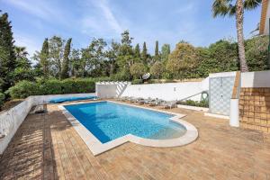 a swimming pool on a brick patio with at Monte Lemos Villa 35 in Luz