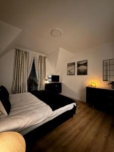 a bedroom with a bed and a christmas tree in the window at Noclegi Margo Dębno in Dębno